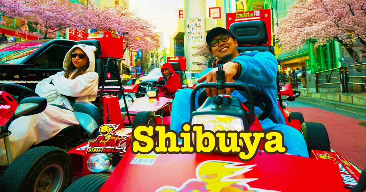 Guided convoy of street go-karts crossing Shibuya Crossing on a Tokyo street go-kart tour in Shibuya, Japan