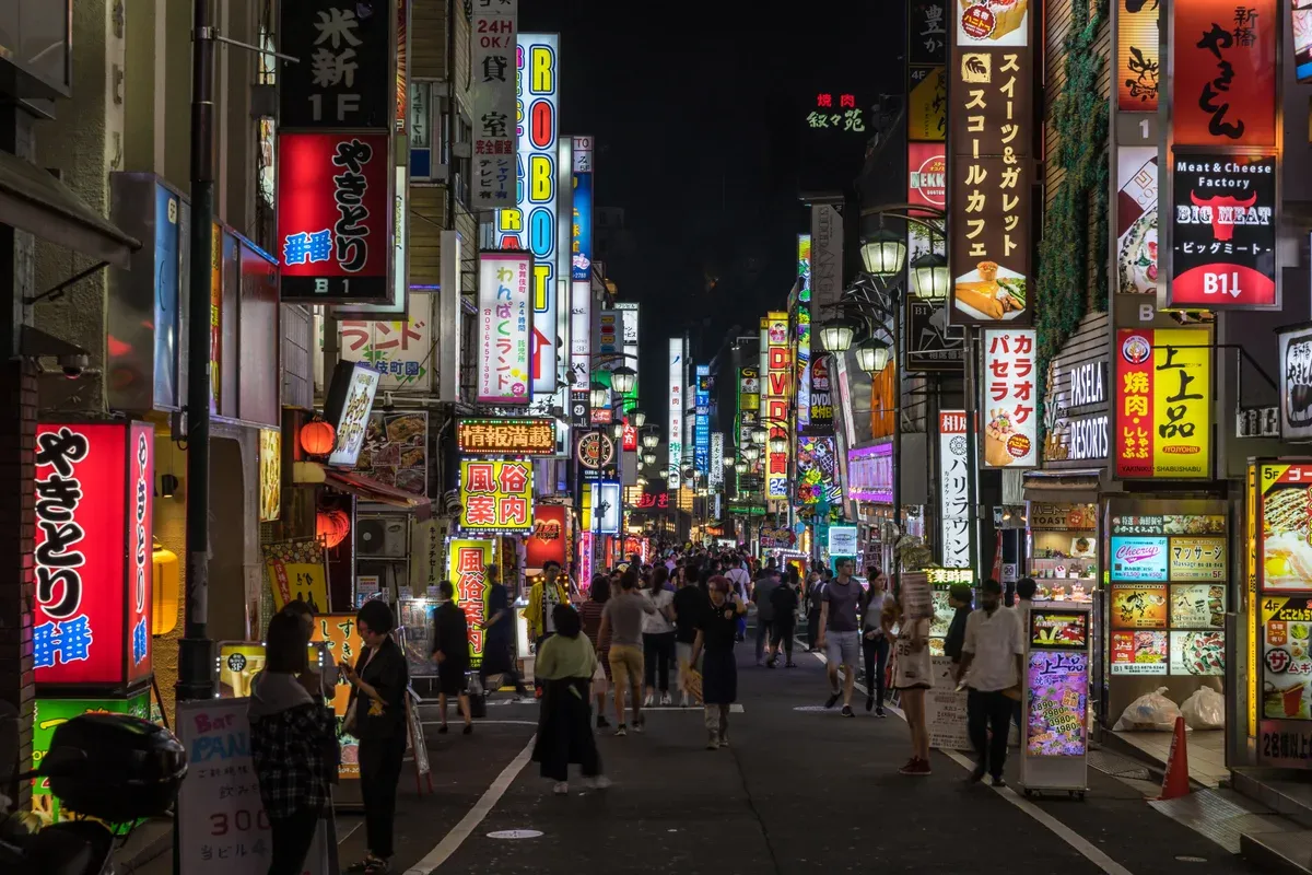 Neon signs of Kabukicho Shinjuku glowing on an evening Tokyo go-kart route in Tokyo, Japan